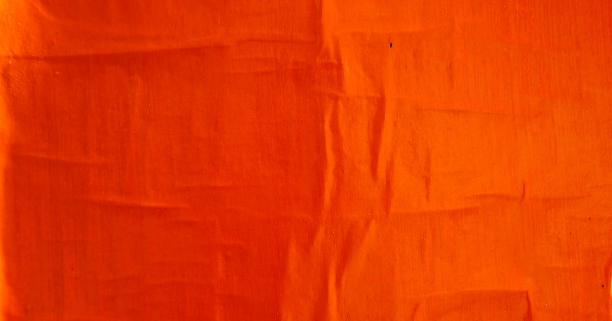 orange textile on white textile